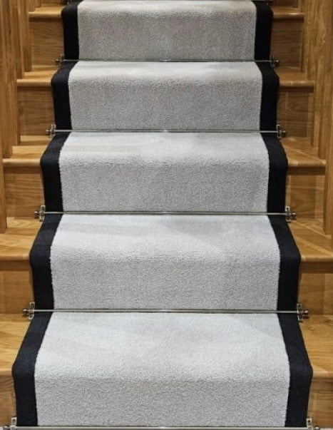 Grey Stairs Carpet with Black Edging and Stair Rods.